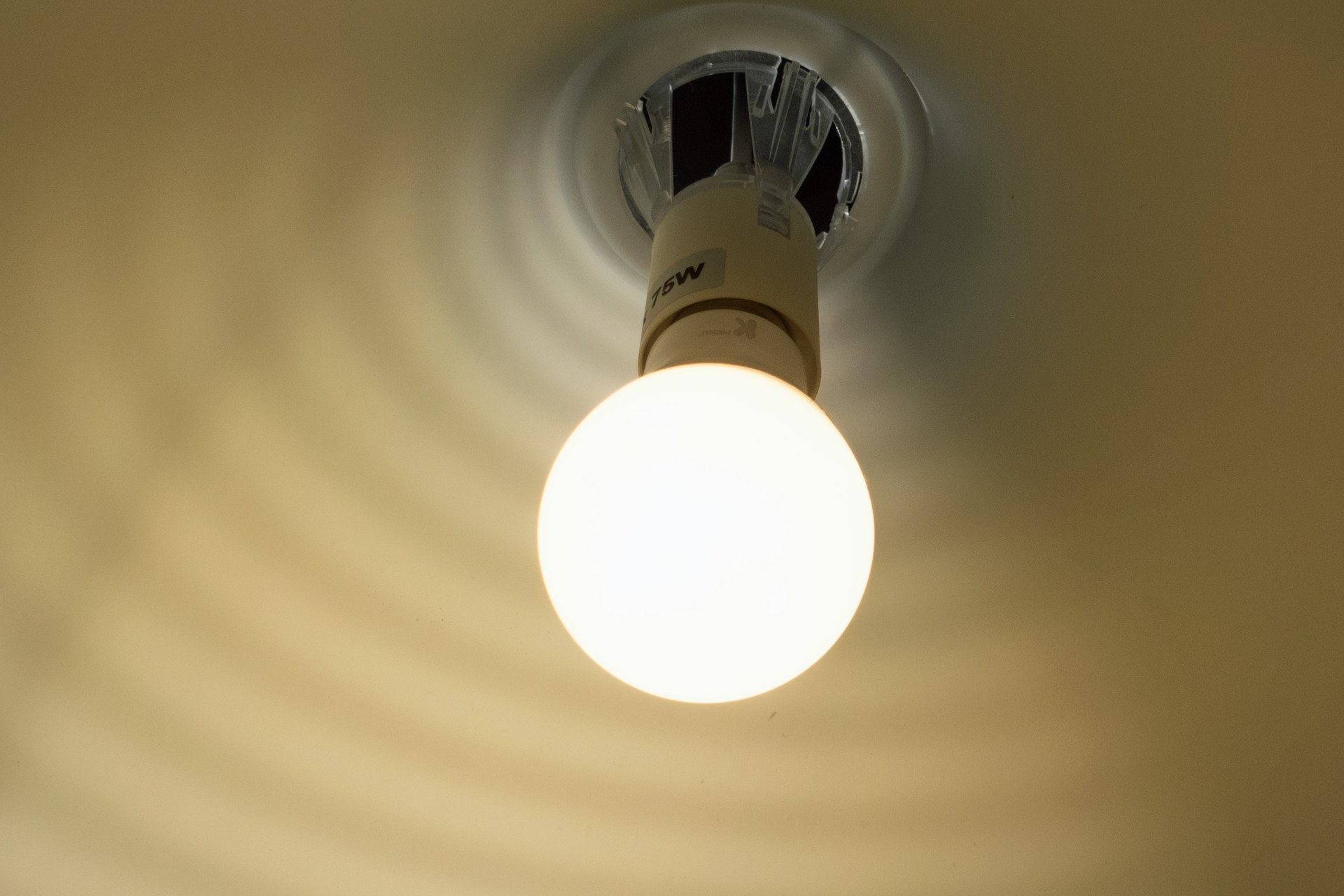 Ceiling-mounted white LED lamp illuminated in an indoor setting